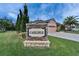 Community sign with manicured landscaping and a view of a well-maintained home in the background at 2903 Marble Crest Dr, Land O Lakes, FL 34638
