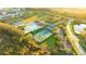 Aerial view of community featuring pool, tennis courts, basketball, and lush landscaping at 3339 Brenford Pl, Land O Lakes, FL 34638