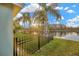 Secluded backyard with a black metal fence and picturesque water views at 3339 Brenford Pl, Land O Lakes, FL 34638