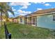 This home features a screened porch and a well-kept backyard with a black metal fence at 3339 Brenford Pl, Land O Lakes, FL 34638