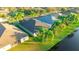 An aerial view of a backyard with mature landscaping and a pond creating a peaceful outdoor space at 3339 Brenford Pl, Land O Lakes, FL 34638