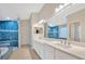 Well-lit bathroom with dual sinks, vanity mirrors, soaking tub, and stylish shower at 3339 Brenford Pl, Land O Lakes, FL 34638