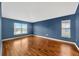 Comfortable bedroom with hardwood floors and a window view at 3339 Brenford Pl, Land O Lakes, FL 34638