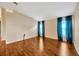 Versatile bonus room featuring hardwood floors, neutral paint, and stylish window treatments at 3339 Brenford Pl, Land O Lakes, FL 34638