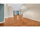 Open-concept dining room with hardwood floors and modern lighting at 3339 Brenford Pl, Land O Lakes, FL 34638