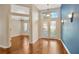 Foyer with hardwood floors, blue accent wall, and stylish lighting at 3339 Brenford Pl, Land O Lakes, FL 34638