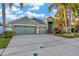Attractive home featuring an expansive driveway, lush landscaping, and a well-maintained lawn at 3339 Brenford Pl, Land O Lakes, FL 34638