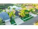 Aerial view of a well maintained home with a two car garage, serene pond and mature palm trees at 3339 Brenford Pl, Land O Lakes, FL 34638