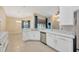 Bright kitchen featuring white cabinets, stainless steel appliances, and an open design to the dining area at 3339 Brenford Pl, Land O Lakes, FL 34638