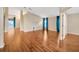 Bright living room features hardwood floors, vaulted ceiling and sliding glass doors to the exterior at 3339 Brenford Pl, Land O Lakes, FL 34638