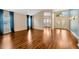 Spacious living room featuring hardwood floors, neutral decor, and plentiful natural light at 3339 Brenford Pl, Land O Lakes, FL 34638
