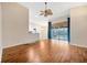 Spacious living room with hardwood floors, neutral paint, and sliding doors leading to a covered patio at 3339 Brenford Pl, Land O Lakes, FL 34638