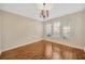 Living room with hardwood floors and natural light from three large windows at 3339 Brenford Pl, Land O Lakes, FL 34638