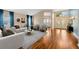 Open living room with hardwood floors, neutral decor, and natural light leading to the foyer at 3339 Brenford Pl, Land O Lakes, FL 34638
