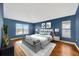 Bright main bedroom featuring hardwood floors and large windows at 3339 Brenford Pl, Land O Lakes, FL 34638