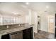 Open view of the kitchen showcasing the stainless steel appliances and granite countertop breakfast bar at 505 E Cluster Ave, Tampa, FL 33604