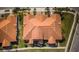 Birds-eye view of a community, showcasing the terra cotta tile roofs and manicured green spaces at 5316 Stoic Vale Dr, Wimauma, FL 33598