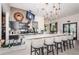 Stylish bar area with granite counters, modern stools, and well-stocked shelves at 5316 Stoic Vale Dr, Wimauma, FL 33598