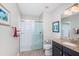 This bathroom features a walk-in shower with glass enclosure, vanity, and modern lighting at 5316 Stoic Vale Dr, Wimauma, FL 33598