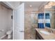 Bathroom showcases a shower with neutral tile, granite counters, and vanity sink at 5316 Stoic Vale Dr, Wimauma, FL 33598