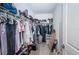 Walk-in closet features ample storage space for clothing and accessories at 5316 Stoic Vale Dr, Wimauma, FL 33598