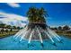 The Southshore Bay community fountain has many spouts of water and is surrounded by stately palm trees at 5316 Stoic Vale Dr, Wimauma, FL 33598