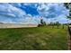 Community dog park area with green grass, chain link fence and open space at 5316 Stoic Vale Dr, Wimauma, FL 33598