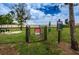 Community dog park area for small dogs with black chain link fence and signage at 5316 Stoic Vale Dr, Wimauma, FL 33598
