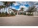 An impressive community entrance with elegant architecture and lush landscaping at 5316 Stoic Vale Dr, Wimauma, FL 33598