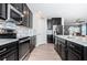 Stylish kitchen boasting stainless steel appliances, white countertops, and a mosaic tile backsplash is perfect for cooking at 5316 Stoic Vale Dr, Wimauma, FL 33598