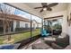 Cozy screened lanai featuring comfortable seating, a ceiling fan, and views of the backyard at 5316 Stoic Vale Dr, Wimauma, FL 33598