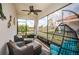Relaxing screened lanai with cozy seating and a beautiful pond view at 5316 Stoic Vale Dr, Wimauma, FL 33598