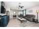 Comfortable living room with a stone accent wall, gray furniture, and an open sliding glass door at 5316 Stoic Vale Dr, Wimauma, FL 33598