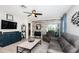 Inviting living room with gray furnishings, a ceiling fan, and an open layout leading to other areas at 5316 Stoic Vale Dr, Wimauma, FL 33598