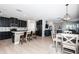 Open living area featuring a kitchen with bar seating, dining area, and a cozy living room setup at 5316 Stoic Vale Dr, Wimauma, FL 33598