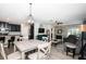 Open-concept living space with a dining area, bar seating, modern lighting, and stylish decor at 5316 Stoic Vale Dr, Wimauma, FL 33598