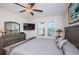 Serene main bedroom featuring plush carpeting, modern furniture, and ample natural light for restful relaxation at 5316 Stoic Vale Dr, Wimauma, FL 33598