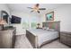 Relaxing main bedroom with a ceiling fan, large windows, and neutral decor creates a peaceful retreat at 5316 Stoic Vale Dr, Wimauma, FL 33598