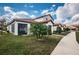 View of the home's rear exterior, screened in porch, lush lawn and mature landscaping at 5316 Stoic Vale Dr, Wimauma, FL 33598
