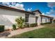 Well-kept single-story home with a terracotta roof, manicured lawn, and a paved walkway to the entrance at 5316 Stoic Vale Dr, Wimauma, FL 33598