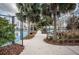 A view of the tennis courts in the community surrounded by landscaping and benches for visitors to relax at 5316 Stoic Vale Dr, Wimauma, FL 33598
