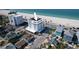 A stunning, sun-drenched aerial view of a multi-story condo building near a beautiful beach at 555 Gulf Way # 7N, St Pete Beach, FL 33706