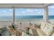 Enjoy breathtaking ocean views from this cozy balcony with comfortable seating and serene atmosphere at 555 Gulf Way # 7N, St Pete Beach, FL 33706
