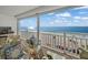Relax on this inviting balcony featuring comfortable seating and panoramic ocean views for tranquil outdoor living at 555 Gulf Way # 7N, St Pete Beach, FL 33706
