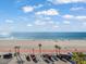 Enjoy ocean views with palm trees and parked cars along the beautiful beach at 555 Gulf Way # 7N, St Pete Beach, FL 33706