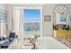 Bedroom featuring a dresser and large window with beautiful views at 555 Gulf Way # 7N, St Pete Beach, FL 33706