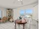 Inviting dining area with a round table, chairs, and a window offering scenic views at 555 Gulf Way # 7N, St Pete Beach, FL 33706