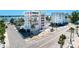 Attractive multi-story building in a tropical setting, complemented by swaying palm trees and ample parking at 555 Gulf Way # 7N, St Pete Beach, FL 33706