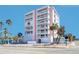 Multi-story condo building in a beachfront area surrounded by palm trees and lush landscaping at 555 Gulf Way # 7N, St Pete Beach, FL 33706