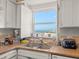 Well-lit kitchen with shuttered window and plenty of counter space for cooking and food preparation at 555 Gulf Way # 7N, St Pete Beach, FL 33706